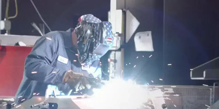 A B&W welder welding with sparks flying.