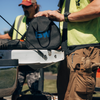workers standing near the tailgate of a pickup with one holding a bag with a B&W logo to carry the ICON lock