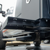 A B&W Trailer Hitches truck underbody retractable step on a work truck in the deployed position.