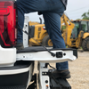 B&W MultiPro hitch installed on a GM pickup with a MultiPro - MultiFlex tailgate and construction equipment in the background.