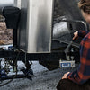 Pickup truck connected with a weight distribution hitch with woman pumping the hydraulic handle.